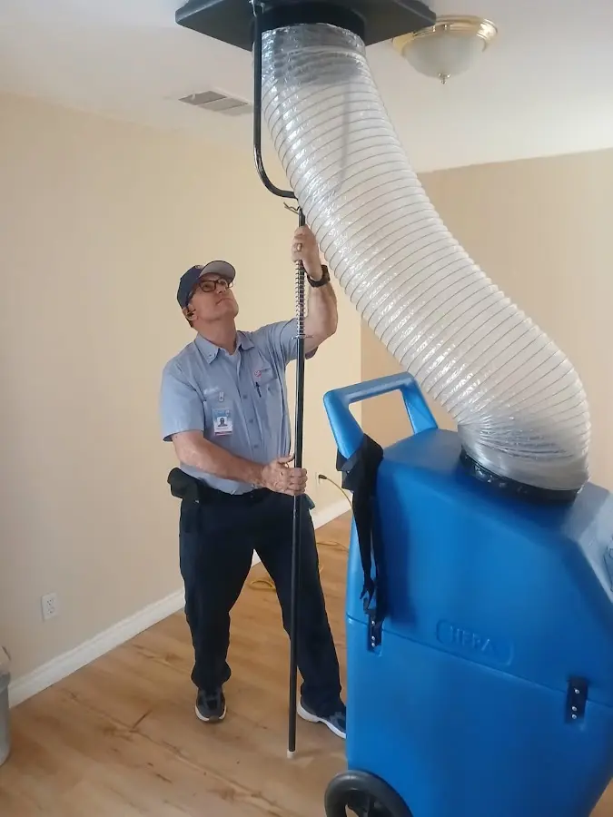 Furnace Tune-Up technician using HEPA equipment in Viera East